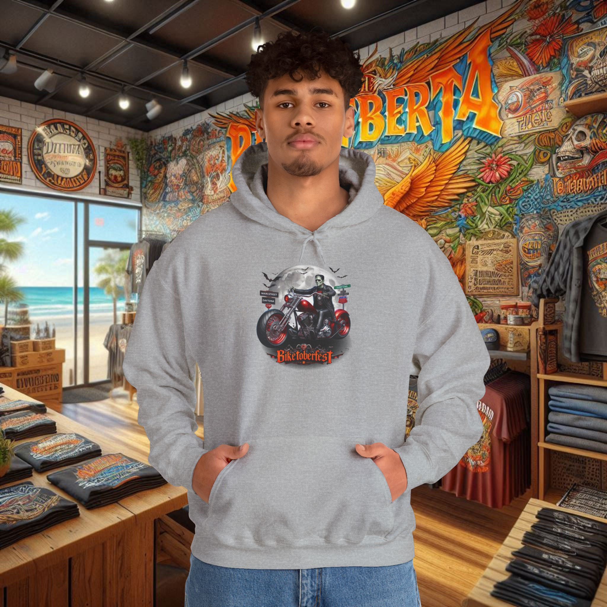 Man wearing a men's biker hoodie with outlaw graphics motorcycle design.