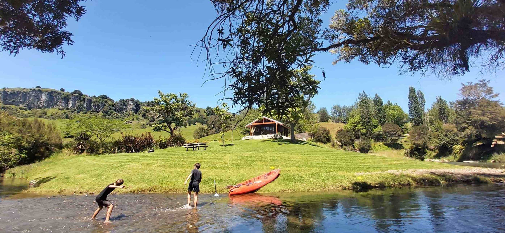 Guests enjoying the private river at Ripples Retreat near Waitomo, New Zealand.