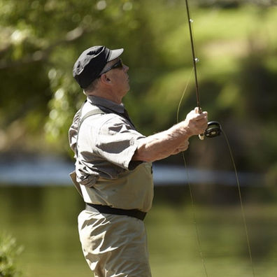 Fisherman fly fishing in beautiful clear river with no other anglers