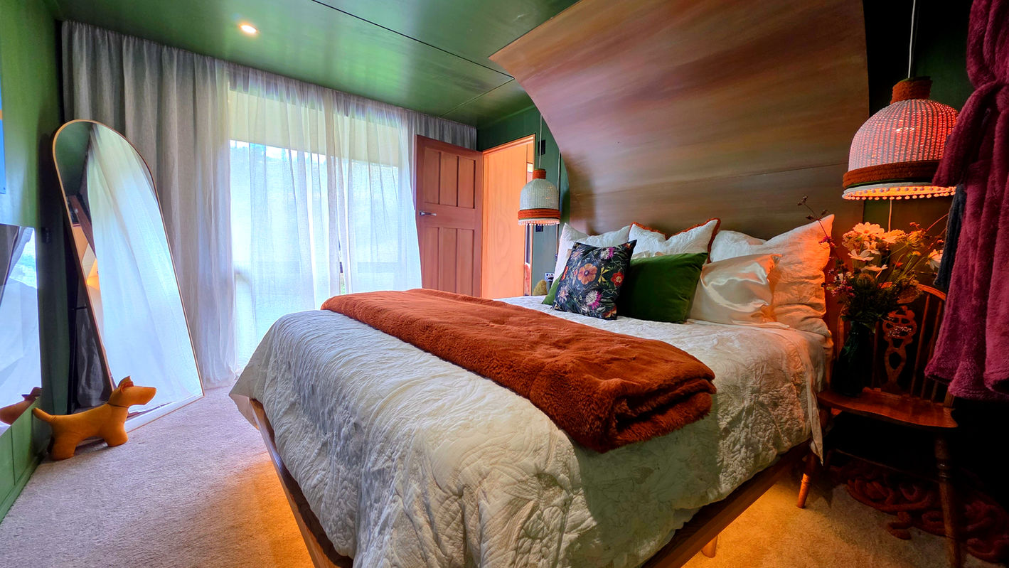 Warm luxury bedroom interior at Ripples Retreat near Waitomo.