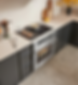 Modern kitchen with food cooking on cooktop and oven