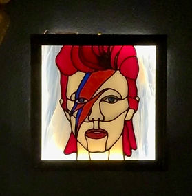 Stained glass portrait inspired by David Bowie’s Aladdin Sane album cover with a red and blue lightning bolt.