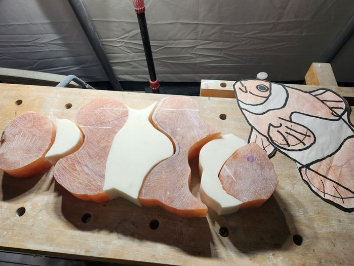 Clownfish wood carving with Nemo's outline and colored details, Finding Nemo background.