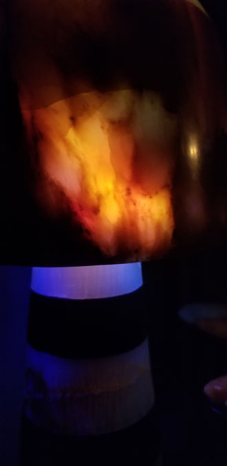 Laminated layers of Brazilian green onyx and Belgian black marble with a green onyx dome. Illuminated with programmable colored LEDs.
28" T x 8" W x 8" D  