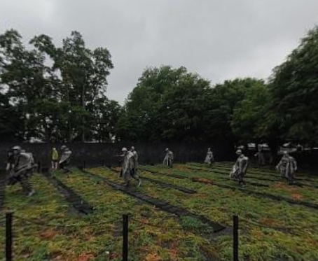 Visitors walk among the stainless-steel soldier statues at the Korean War Veterans Memorial in Washington, D.C., during steady rain on June 28, 2026, as families and tourists continue to honor those who served in the Korean War despite the wet weather.