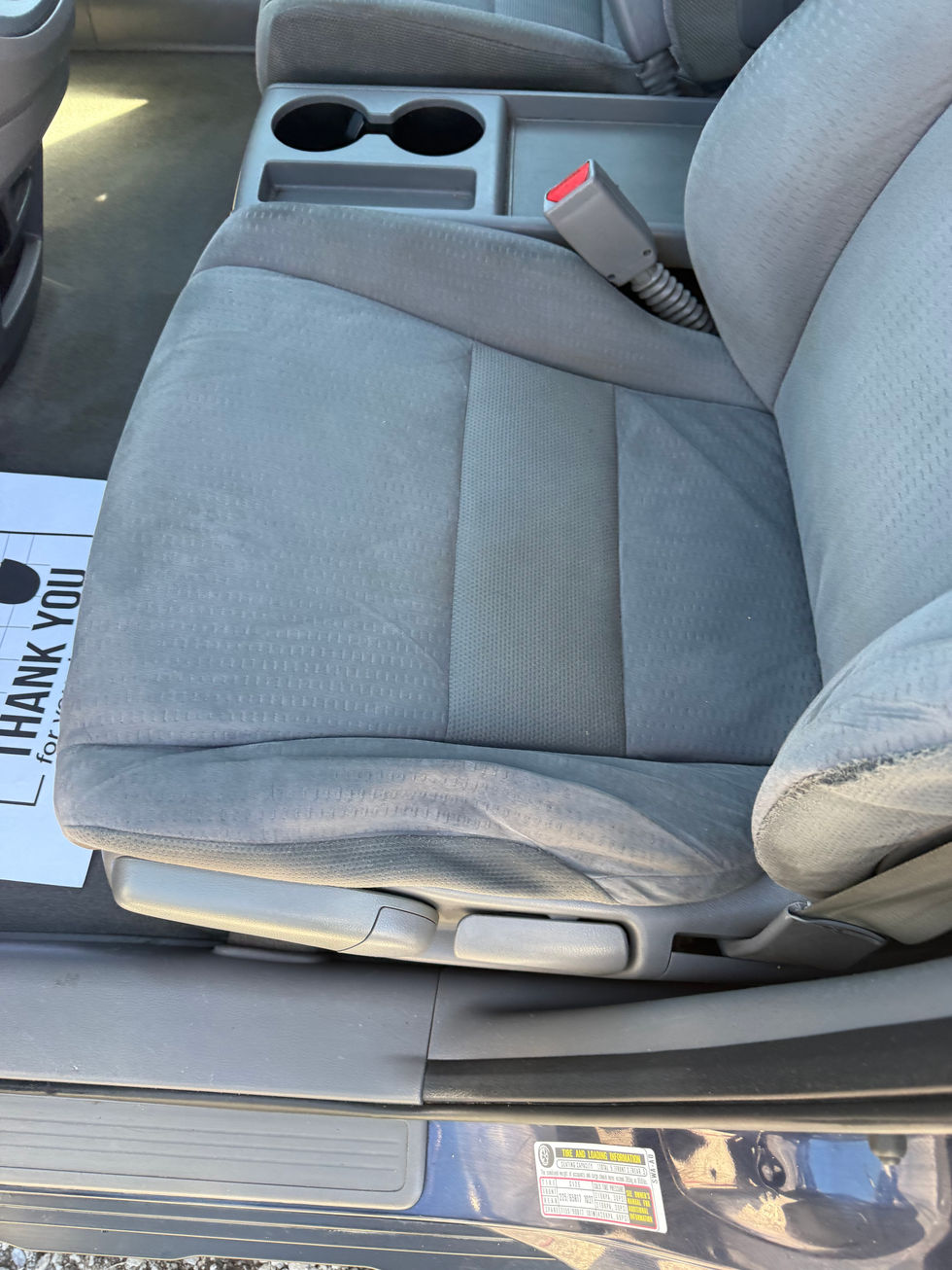 Car seat with gray upholstery.