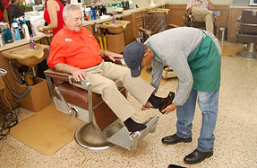 Man getting shoes shined at Avalon Barbershop
