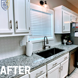 kitchen with white cabinets, granite countertop, farmhouse sink, and white tile floor