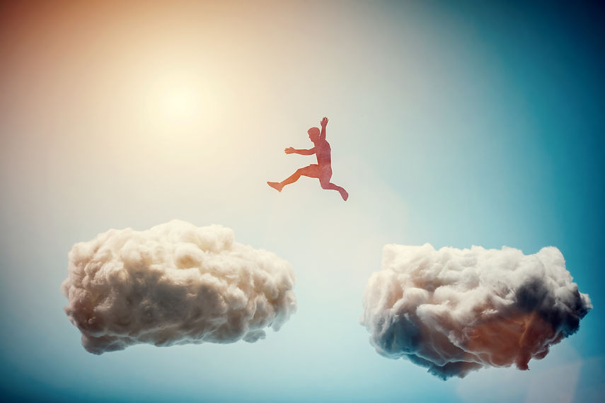 Man jumping from one cloud to another. Taking risks and challenge concept. Overcoming prob