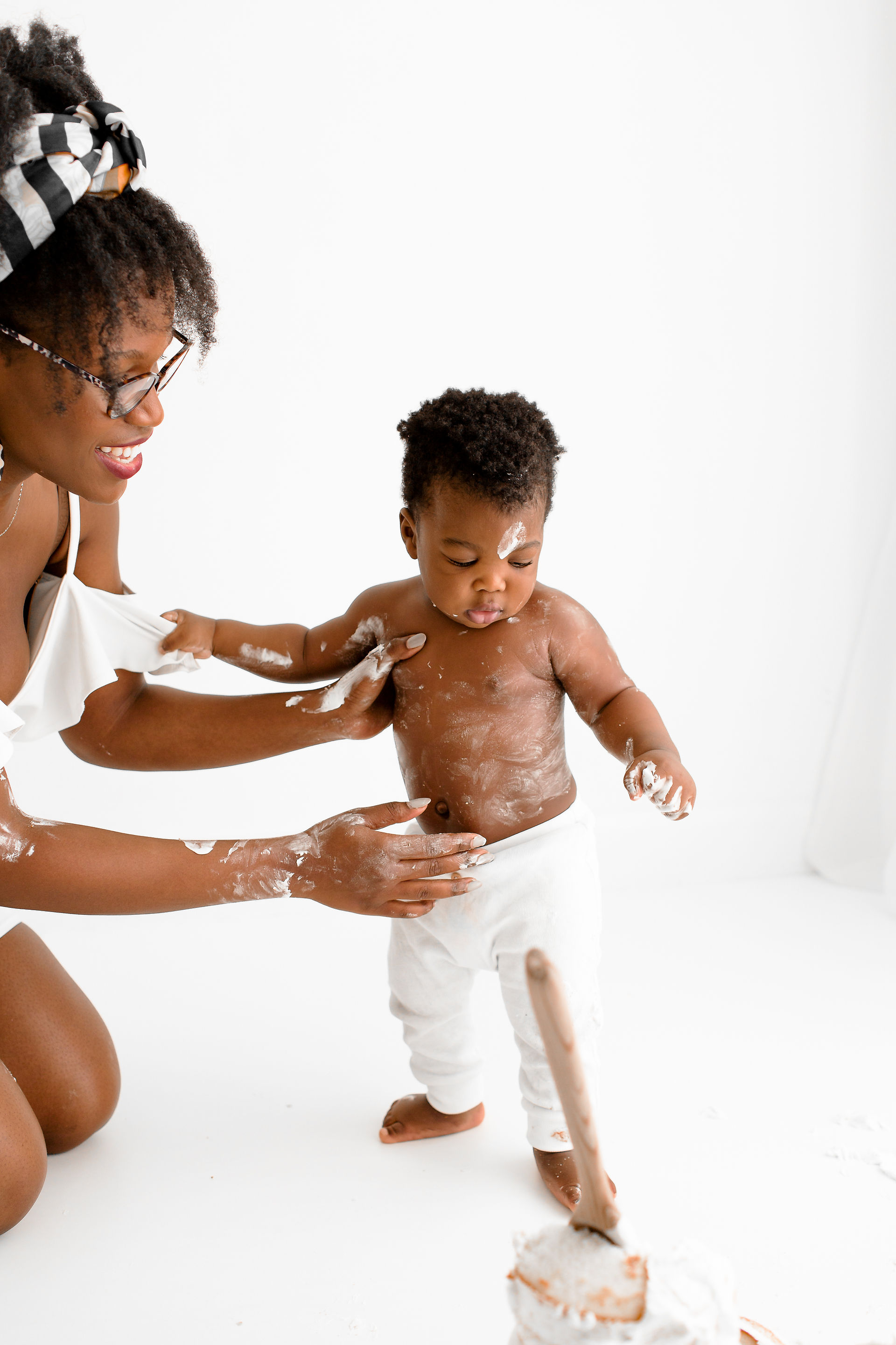 mum and baby lagging covered in white cake buttercream