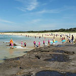 A group of nippers walking into the water