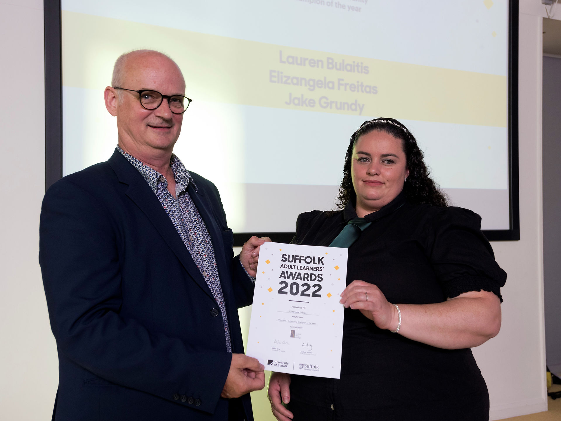 group of people holding certificate and smiling