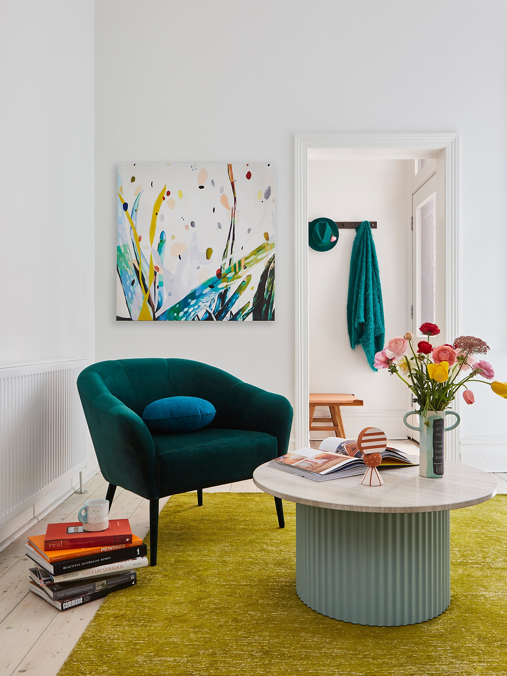 living room with teal green sofa