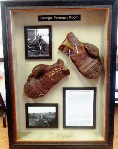 Custom shadowbox frame displaying boxing gloves with structured mounting and depth spacing.
