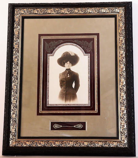 Vintage portrait photograph framed with layered matting and traditional moulding profile.