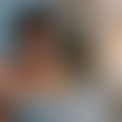 Woman looking at laptop smiling and waving