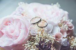 gold-colored bridal ring set on pink rose flower bouquet_edited.jpg