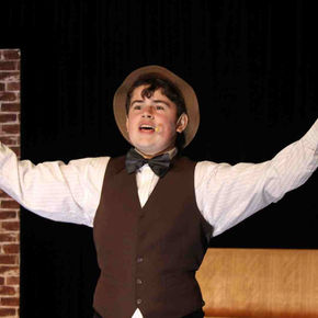 Actor in vintage clothes performs on stage