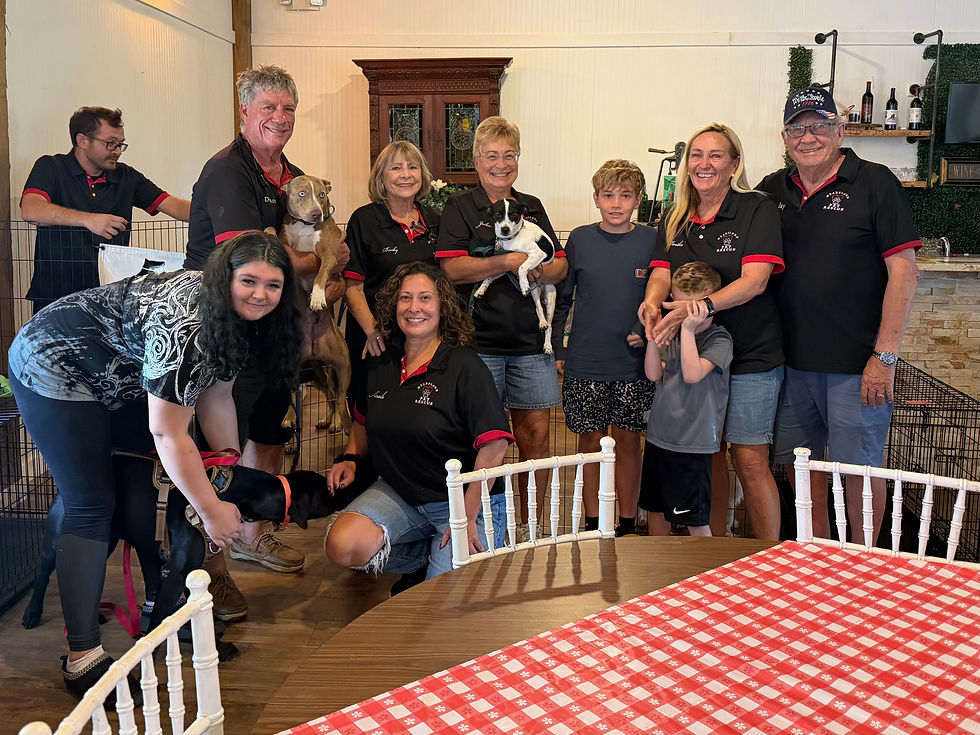 Group photo of Heartland Pet Rescue volunteers and supporters with dogs