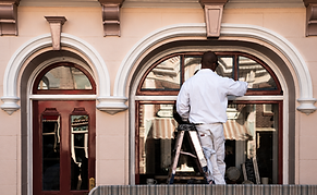 "Historic commercial building exterior restored with professional painting services"