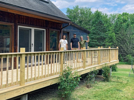 Rebuilt residential deck with replaced wood, railings, and fasteners on preserved foundation