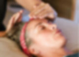 hands over womans head receiving reiki