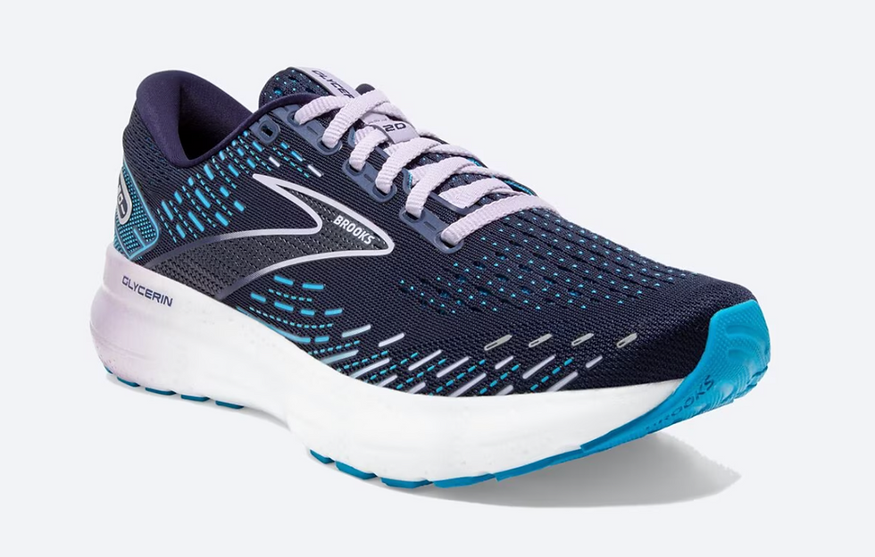 Blue and white Brooks running shoe with teal accents, featuring a mesh design. Brand and model names visible on sides against a plain background.