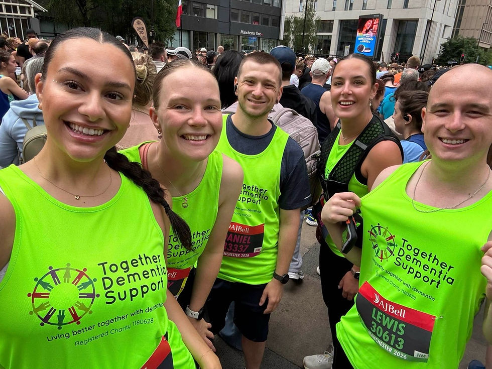 Smiling runners in neon green Together Dementia Support shirts pose at a crowded city race start.
