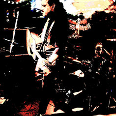 Color-adjusted photo, mostly sepia two-tone, of The King Teen, holding a guitar, in a club. 