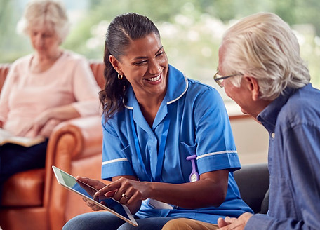 Healthcare provider discussing wellness needs with an older resident