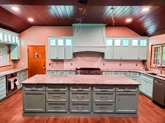 Progress. Wall removed, blue cabinetry and chef grade appliances, stained shiplap ceiling, recessed lighting and getting ready for pendant lights