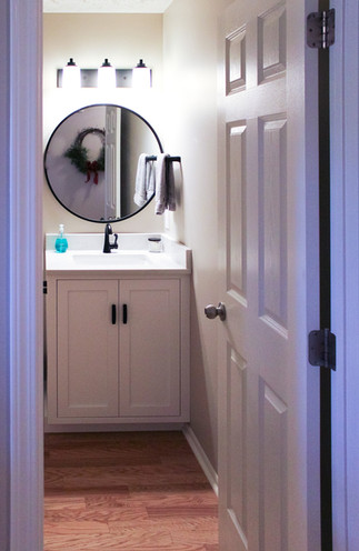 Entry to the half bath and theme of Black and White