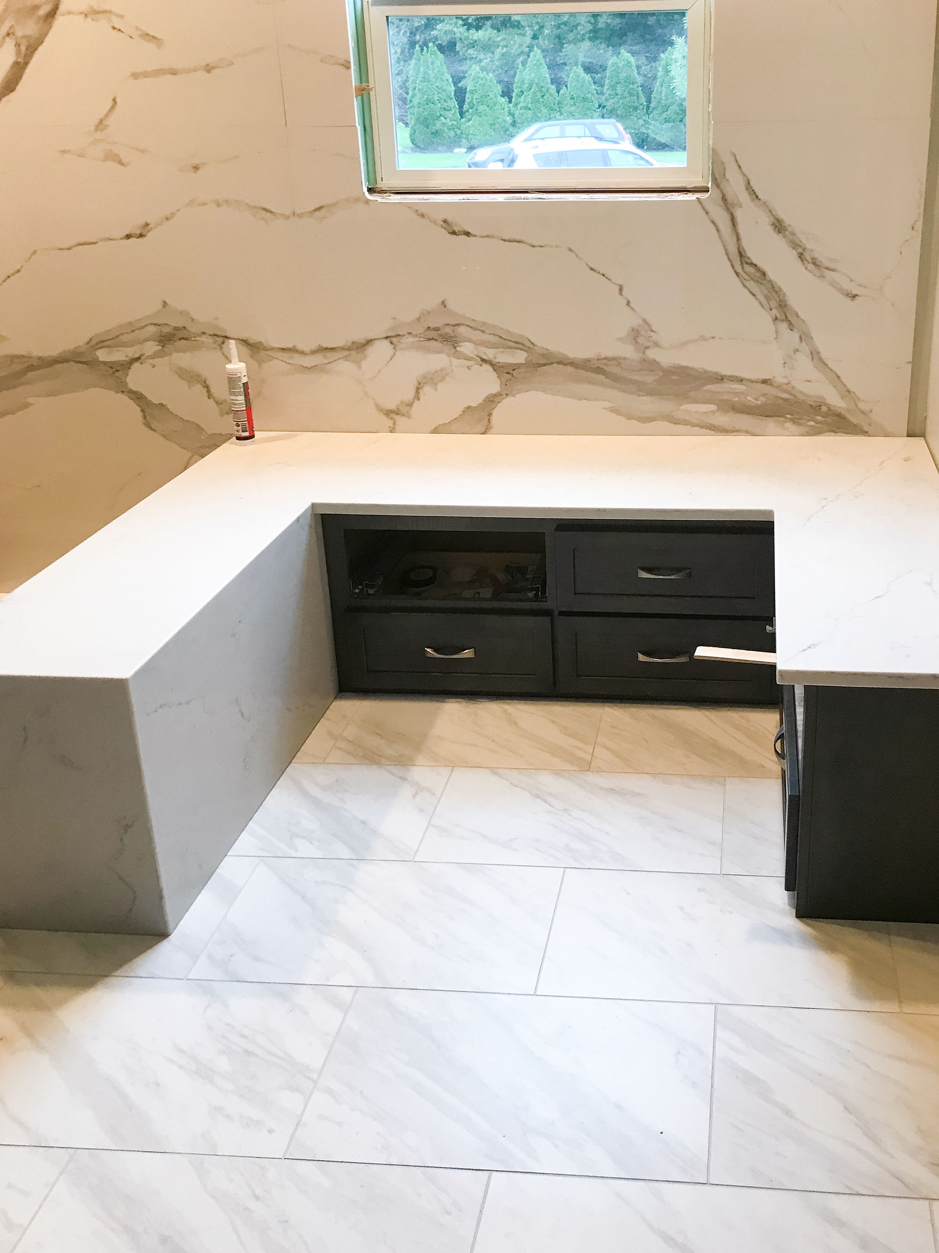 Primary bath seating and storage area
