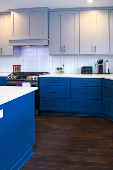 Indigo blue drawers of the inlayed lower kitchen cabinets of the Two-Story Addition by Barrett Home Renovations