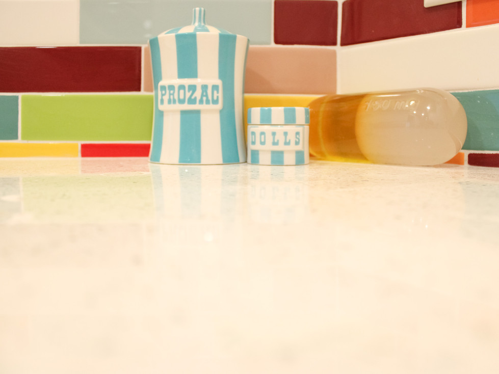 Client added their own fun vanity jars in the Colorful Flashback bathroom by Barrett Home Renovations