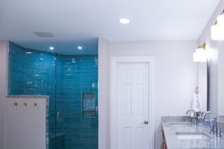 Quartzite vanity counter top matches the quartz in the shower in A Dusty To Darling Bathroom by Barrett Home Renovations