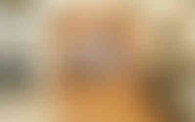 Passage way from living room to kitchen with pendants lights glowing above center island