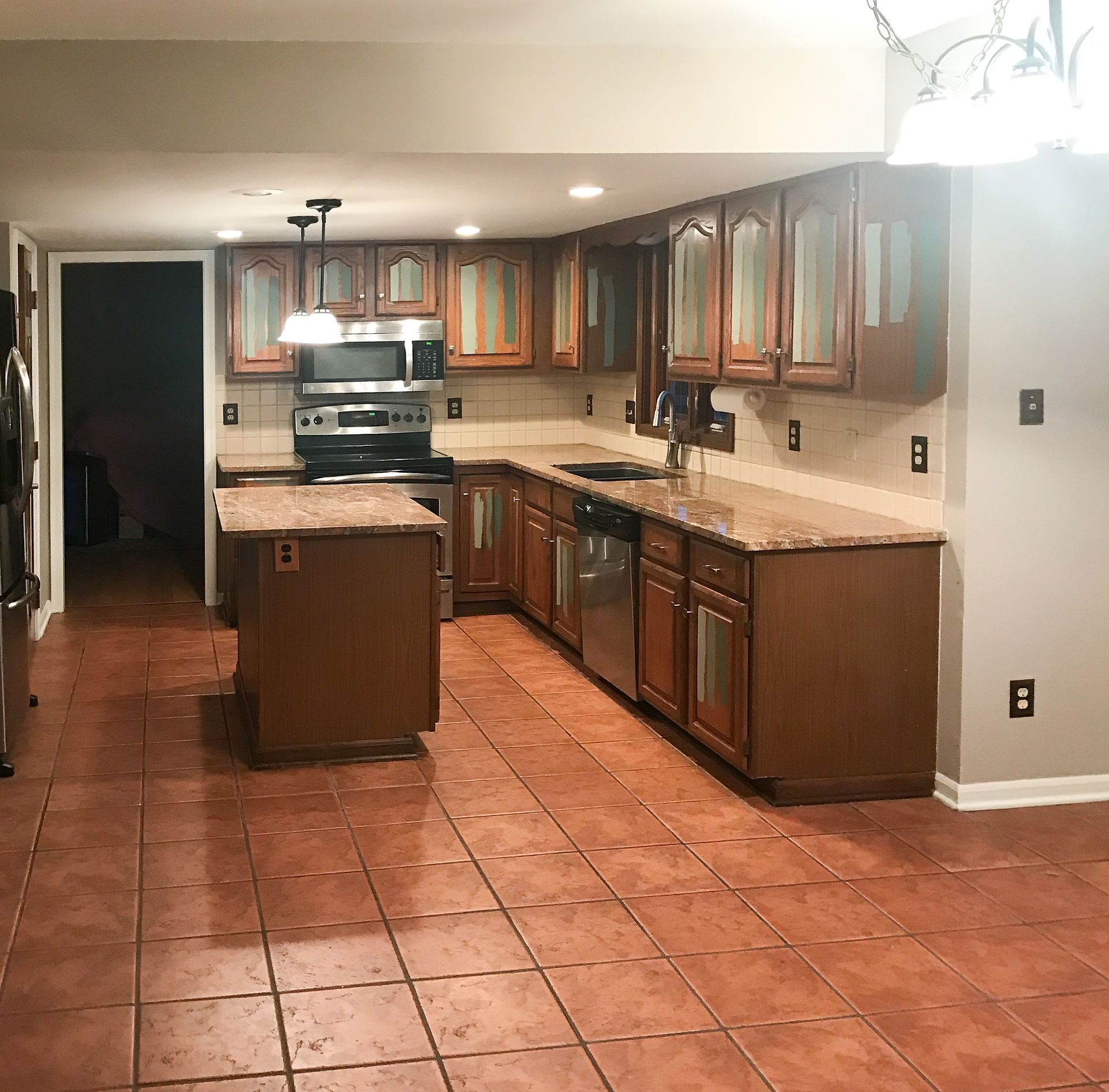 Entire ceiling of former kitchen was in a soffit, and square floor tiles in a stacked pattern were lackluster