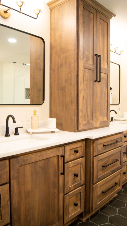 Sconce lighting above two mirrors of the double vanity with stained cabinetry in Rooms With A CBUS View by Barrett Home Renovations
