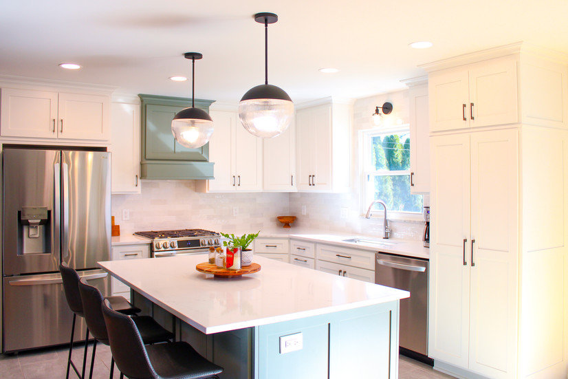 Built-in kitchen cabinets and pantry closet make great use of space in the Sage Green Kitchen by Barrett Home Renovations 