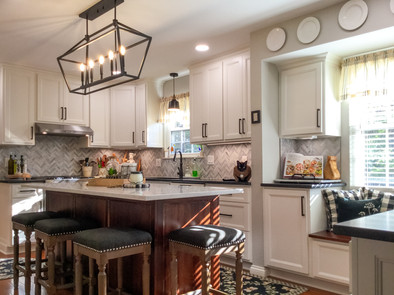 Wrought iron, 5-light lantern style pendant light above center island makes a grand statement in the Cat's Meow Kitchen by Barrett Home Renovations
