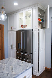 Push panel storage openings in built in kitchen cabinetry