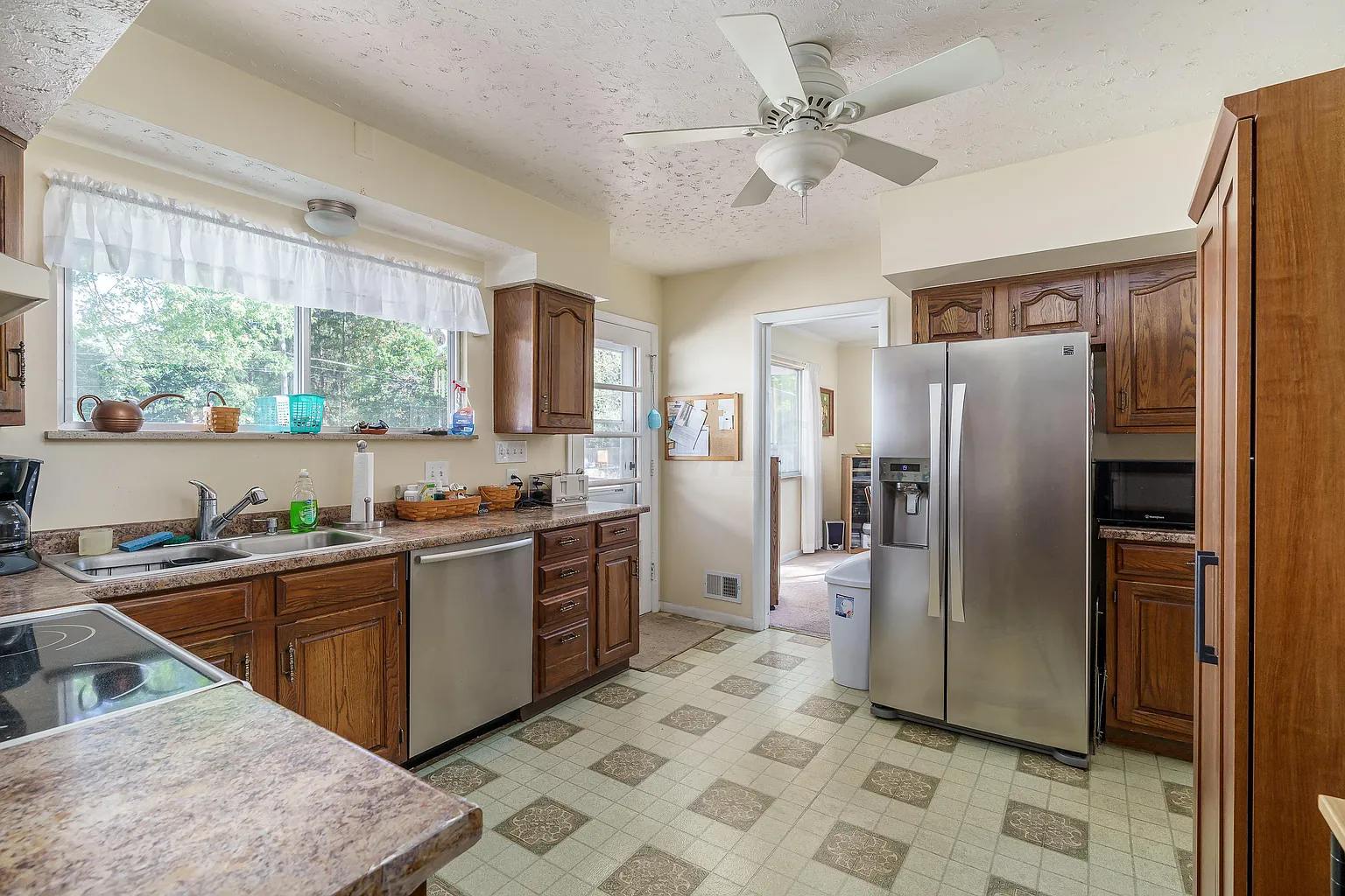 Kitchen with low overhead fan light 