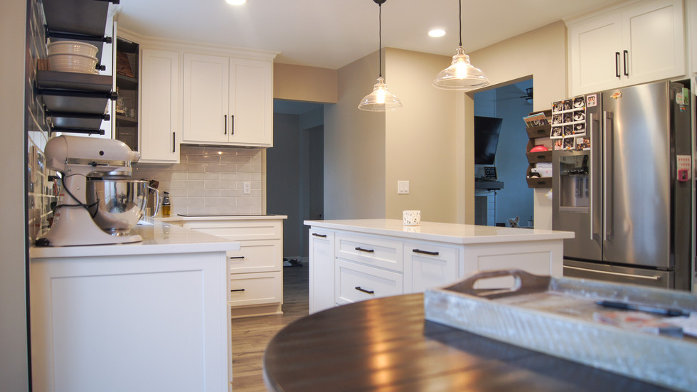 Center island features waste basket pullout and soft close drawers in Roger's Family Home by Barrett Home Renovations