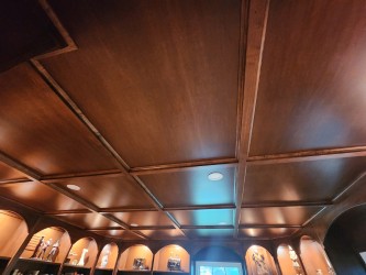 Stained coffered ceiling has a distinguished polish and reflective quality 