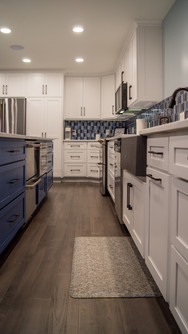 Galley of built in Amish cabinetry give a warm glow under the recessed ceiling lights
