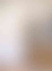 Soft white painted floor to ceiling cabinets surround the French door style refrigerator