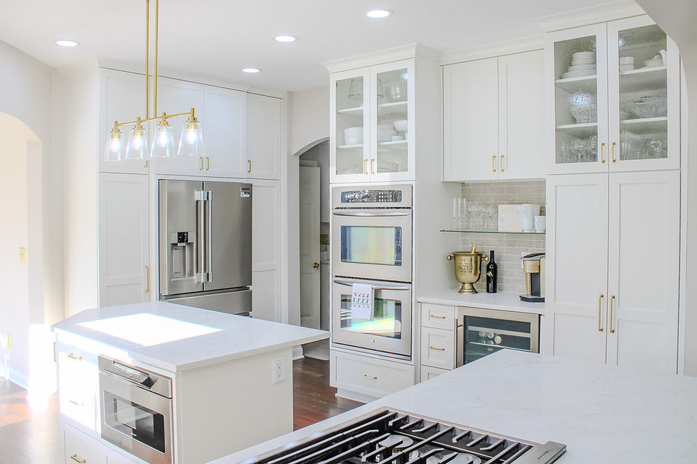 White on white kitchen with stainless steal appliances and gold pendant lighting