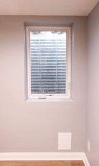direct view of fully encased egress window with natural light pouring in