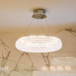 Lighted chandelier with porcelain in background
